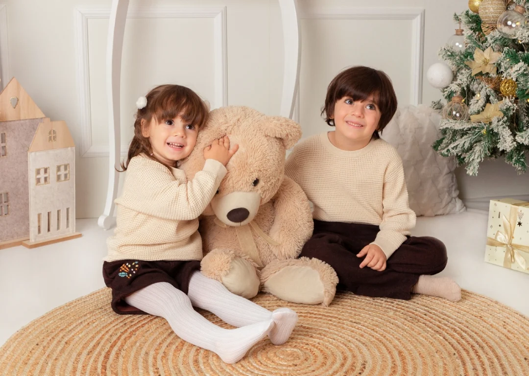 Hermanos con osito de peluche en sesión de Navidad en Guadarrama, Madrid